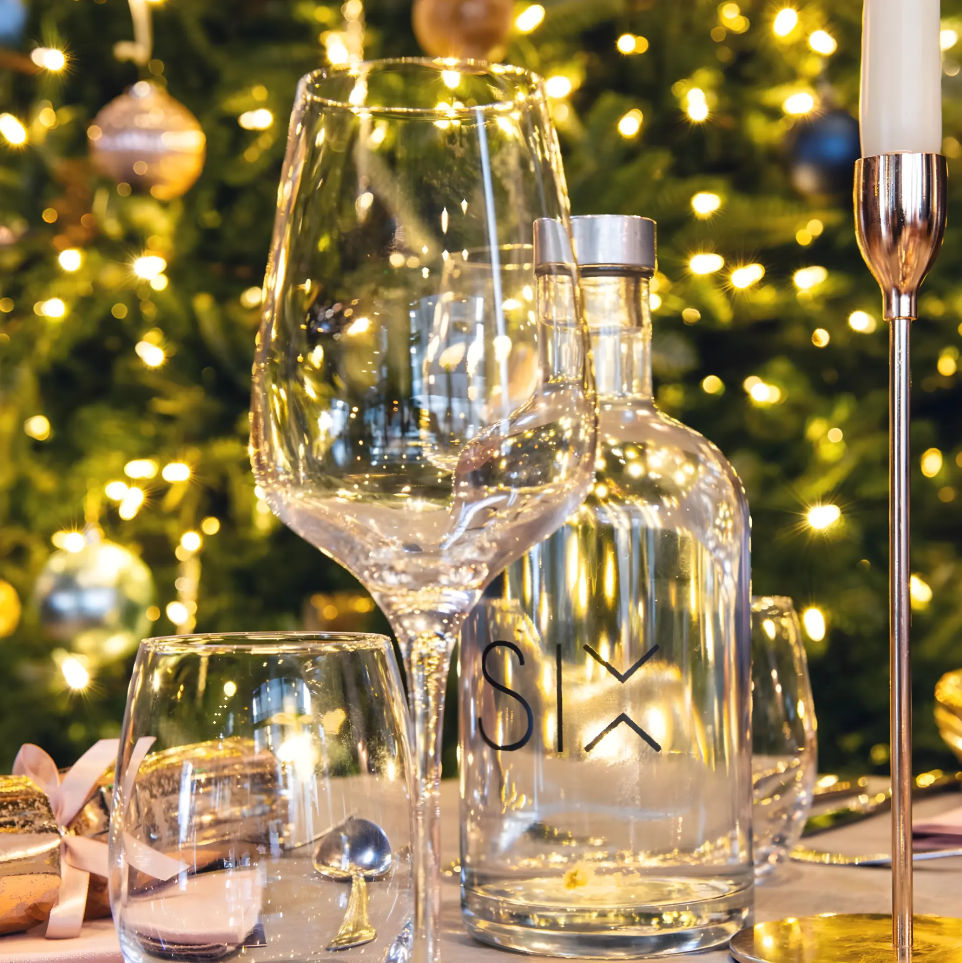 SIX carafe and glasses set before the lit Christmas tree