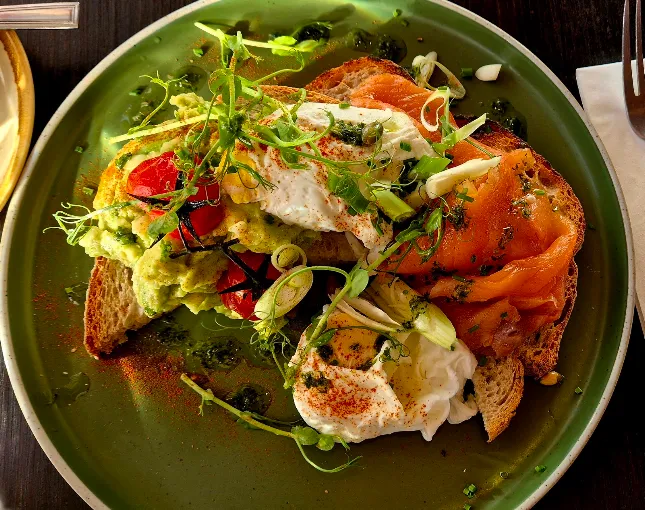 Brunch with avocado, poached eggs and smoked salmon at SIX