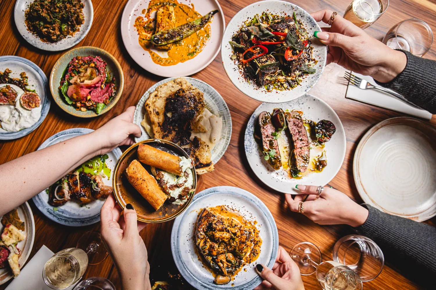 A table covered in plates of dishes and glasses at SIX
