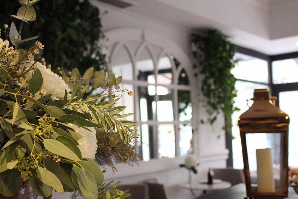Flowers and a lantern in a light-filled corner of SIX