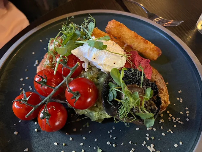Avocado toast with poached egg, tomatoes and mushrooms at SIX